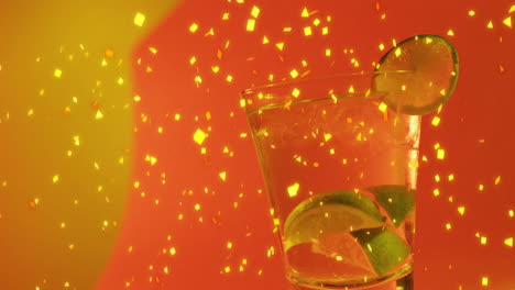 Animation-of-confetti-falling-and-cocktail-on-red-background