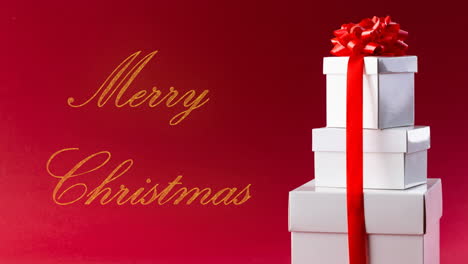 Animation-of-merry-christmas-text-and-christmas-gifts-on-red-background