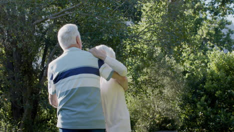 Happy-senior-caucasian-couple-dancing-in-sunny-garden,-slow-motion