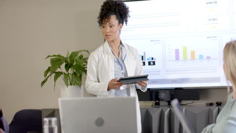 African-american-female-doctor-using-tablet-with-copy-space,-slow-motion