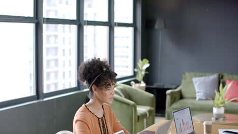 African-american-business-woman-using-laptop-in-office-with-copy-space