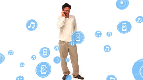 Animation-of-connected-icons,-biracial-man-talking-on-phone-and-standing-against-white-background