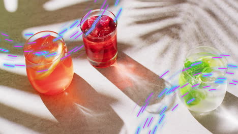 Animation-of-light-trails-and-cocktails-on-white-background
