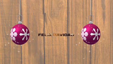 Animation-of-feliz-navidad-text-and-christmas-baubles-on-woodenbackground