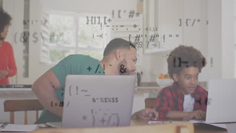 Animation-of-multiple-symbols-over-diverse-father-helping-son-in-using-laptop-at-home