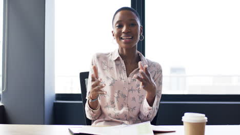 Portrait-of-smiling-african-american-businesswoman-in-office,-slow-motion,-copy-space