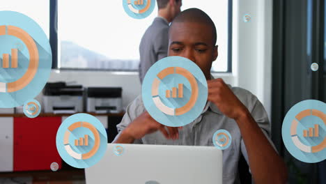Animation-of-multiple-graph-icons-over-tired-african-american-man-looking-at-laptop-in-office