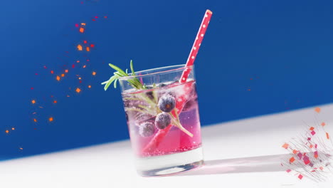 Animation-of-confetti-falling-and-cocktail-on-blue-background