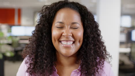 Portrait-of-smiling-casual-biracial-businesswoman-in-office,-slow-motion-with-copy-space