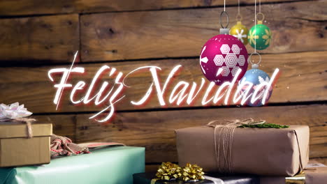 Animation-of-feliz-navidad-text-and-christmas-bauble-on-wooden-background