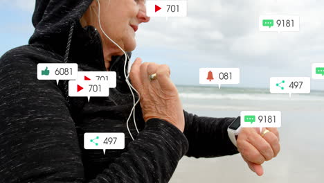 Animation-of-notification-bars-over-senior-caucasian-woman-with-headphone-using-smartwatch-at-beach