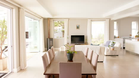 General-view-of-light-modern-interiors-with-dining-room-table-and-chairs,-copy-space,-slow-motion