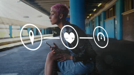 Animation-of-flowchart-of-icons-over-biracial-woman-using-phone-while-waiting-for-train-at-station