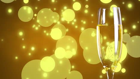 Animation-of-glass-of-champagne-on-yellow-background