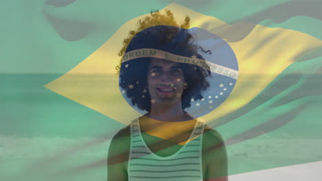 Animation-of-waving-flag-of-brazil-over-biracial-man-standing-against-ocean-at-beach
