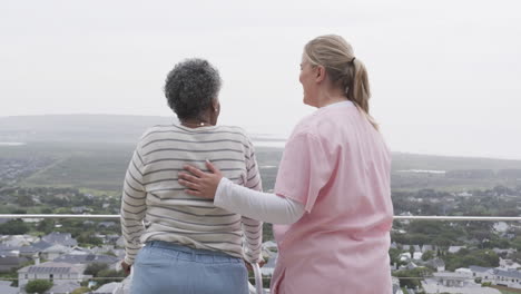 Caucasian-female-nurse-with-senior-african-american-woman,-copy-space,-slow-motion