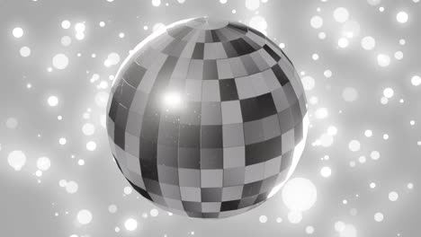 Animation-of-mirror-disco-ball-spinning-over-spots-of-lights-on-grey-background