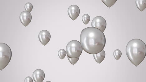 Animation-of-silver-balloons-over-white-background