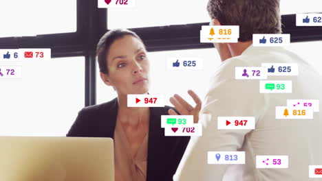 Animation-of-notification-icons-with-numbers-over-caucasian-colleagues-discussing-over-laptop