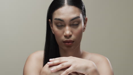 Biracial-woman-with-black-hair-and-make-up-looking-at-camera,-copy-space,-slow-motion