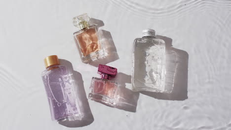 Video-of-beauty-product-bottles-in-water-with-copy-space-on-white-background