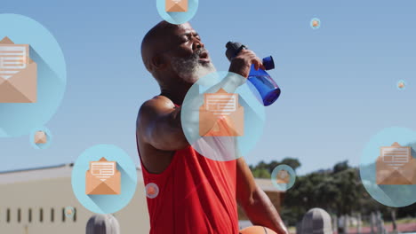Animation-Von-Symbolen-über-Müden-älteren-Afroamerikanern-Mit-Basketball-Trinkwasser