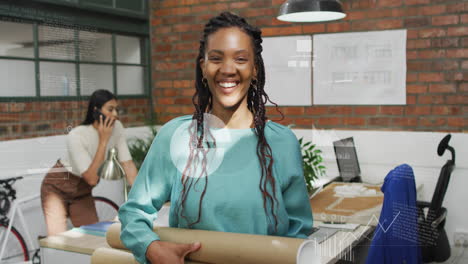 Animation-of-graphs-and-icons-over-smiling-biracial-woman-standing-and-holding-cardboard-rolls