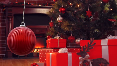 Animation-of-christmas-bauble-over-christmas-tree-and-gifts-background