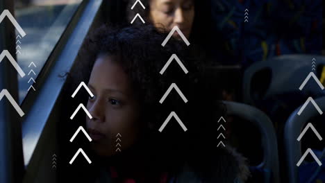Animation-of-multiple-up-arrows-over-thoughtful-biracial-girl-looking-through-glass-window-of-bus
