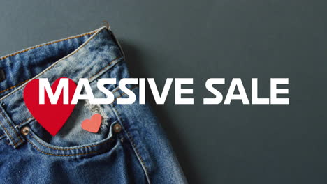 Animation-of-massive-sale-text-over-denim-trousers-background