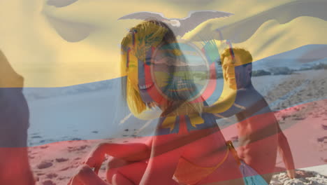 Animation-of-flag-of-ecuador-waving-over-diverse-friends-enjoying-at-beach