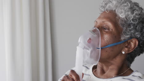Senior-african-american-woman-with-oxygen-mask,-copy-space,-slow-motion
