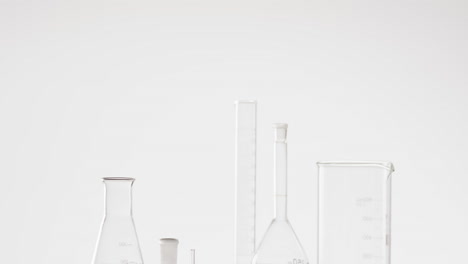 Video-of-glass-laboratory-beakers-and-dishes-with-copy-space-on-white-background