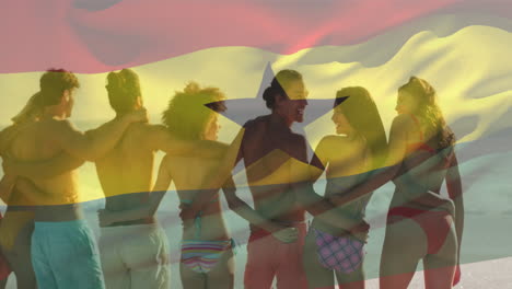 Animation-of-waving-ghana-flag-over-diverse-friends-standing-and-forming-chain-at-beach