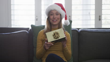 Happy-biracial-woman-wearing-santa-hat-having-christmas-video-call,-in-slow-motion