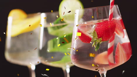 Animation-of-confetti-falling-and-cocktails-on-black-background