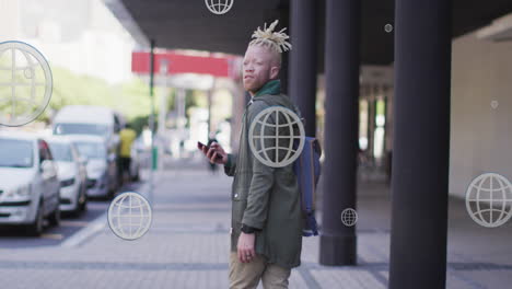 Animation-of-globe-icons-over-albino-african-american-man-walking-while-looking-backward-on-street
