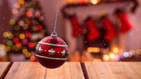 Animation-of-red-christmas-bauble-over-christmas-tree-and-snow-falling-background