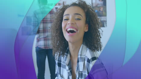 Animation-of-purple-to-green-layers-smiling-biracial-woman-in-office