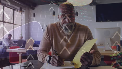 Animation-of-arrows,-graphs-and-trading-over-african-american-man-discussing-on-video-call