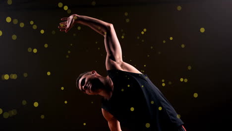 Animation-of-caucasian-basketball-player-stretching-and-spots-of-light-on-black-background