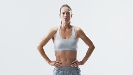Fit-young-Caucasian-woman-athlete-stands-confidently-on-a-white-background,-with-copy-space