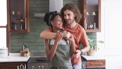 Diverse-couple-enjoys-a-cozy-moment-in-the-kitchen