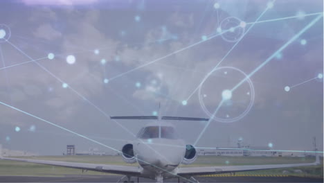 Animation-of-connected-dots-over-parked-airplane-against-cloudy-sky-at-airport