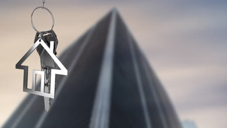 Animation-of-silver-key-and-house-over-blurred-tall-building