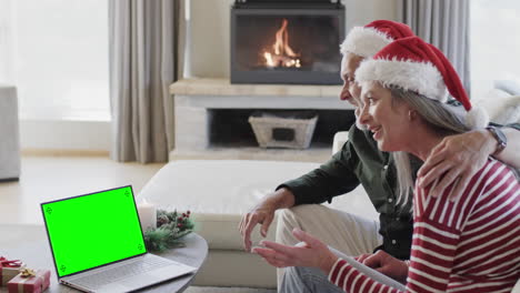 Happy-caucasian-couple-having-christmas-laptop-video-call-with-green-screen,-slow-motion