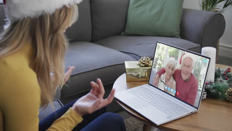 Happy-caucasian-daughter-and-senior-parents-having-christmas-laptop-video-call,-slow-motion