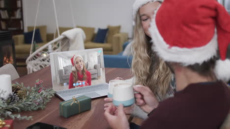 Happy-caucasian-couple-and-female-friend-having-christmas-laptop-video-call,-slow-motion
