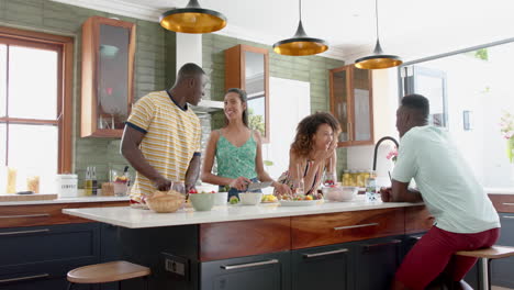 Diverse-group-enjoys-a-conversation-in-a-modern-home-kitchen