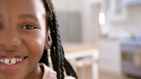 Portrait-of-happy-african-american-girl-with-long-hair-at-home,-slow-motion,-copy-space